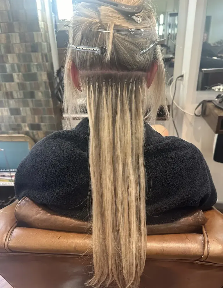 Nano rings during the fitting: a row of tiny connections at the back of the head, each strand worked in one by one